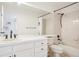 Bright bathroom featuring a large mirror, tub-shower combo, and a white vanity with dark hardware at 742 Norwich Ct, Castle Pines, CO 80108