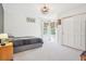 Bright bedroom with a bed, closet, and windows dressed with curtains and woven shades at 742 Norwich Ct, Castle Pines, CO 80108