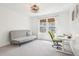Bedroom featuring a sofa and desk near a window with curtains and woven shades at 742 Norwich Ct, Castle Pines, CO 80108