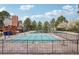 A community pool and sun deck enclosed by wrought iron fencing and mature trees at 742 Norwich Ct, Castle Pines, CO 80108