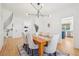 Bright dining room with wainscoting, hardwood floors, and pendant lighting at 742 Norwich Ct, Castle Pines, CO 80108