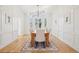Elegant dining room with wainscoting, hardwood floors, and modern lighting at 742 Norwich Ct, Castle Pines, CO 80108