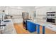 Modern kitchen featuring stainless steel appliances, white cabinets, granite countertops, and center island at 742 Norwich Ct, Castle Pines, CO 80108