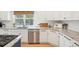 Bright kitchen featuring stainless steel dishwasher, undermount sink, white cabinets, and granite countertops at 742 Norwich Ct, Castle Pines, CO 80108