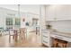Bright kitchen features white cabinets, stainless appliances, and a charming breakfast nook with access to the outdoors at 742 Norwich Ct, Castle Pines, CO 80108