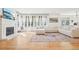 Stylish living room with a fireplace, hardwood floors, and large windows at 742 Norwich Ct, Castle Pines, CO 80108