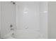 Bright bathroom featuring a tile surround bathtub and shower with classic fixtures at 12348 W Dorado Pl # 204, Littleton, CO 80127