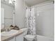 Bathroom with a vanity, toilet, and tiled shower featuring a floral curtain at 12348 W Dorado Pl # 204, Littleton, CO 80127