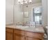 Functional bathroom with a wood vanity, large mirror, and easy access to shower at 12348 W Dorado Pl # 204, Littleton, CO 80127