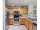 Well-lit kitchen featuring stainless steel appliances and wood cabinetry at 12348 W Dorado Pl # 204, Littleton, CO 80127