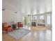 Bright living room with a cozy fireplace and sliding glass door to the balcony at 12348 W Dorado Pl # 204, Littleton, CO 80127