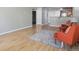 Open-concept living area with wood floors seamlessly flowing into the kitchen space at 12348 W Dorado Pl # 204, Littleton, CO 80127