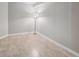 Bright room featuring tile flooring, light-colored walls, and a tall standing lamp at 12348 W Dorado Pl # 204, Littleton, CO 80127