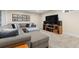 Cozy basement featuring a comfy sectional, carpet, and a modern entertainment center at 452 Deframe Ct, Golden, CO 80401