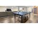 Large finished basement with ping pong table, comfy sofa, and entertainment center at 452 Deframe Ct, Golden, CO 80401