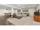 Finished basement with large sectional, ping pong table, and carpeted floors at 452 Deframe Ct, Golden, CO 80401