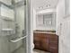 Contemporary bathroom featuring a walk-in shower with tiled walls and dark wood vanity at 452 Deframe Ct, Golden, CO 80401