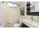 This bathroom features a modern sink, toilet, and shower with white subway tile, creating a clean and contemporary space at 452 Deframe Ct, Golden, CO 80401