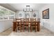 Well-lit dining area featuring tile floors, a modern light fixture, and stylish decorative elements at 452 Deframe Ct, Golden, CO 80401