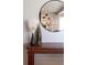 Close up of a wooden table with decor items against a mirrored wall at 452 Deframe Ct, Golden, CO 80401