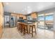Kitchen with wood cabinets, stainless steel appliances, and backyard access through sliding glass doors at 452 Deframe Ct, Golden, CO 80401