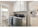 Laundry room with modern washer and dryer, storage, and easy access to an adjacent bathroom at 452 Deframe Ct, Golden, CO 80401