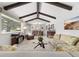 Open living room features vaulted ceilings with exposed beams, carpet flooring, and a large picture window at 452 Deframe Ct, Golden, CO 80401