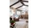 A living room and dining area, with a large window and exposed beams at 452 Deframe Ct, Golden, CO 80401