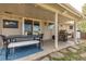 This covered outdoor patio has a BBQ, dining set, and accent lights, creating the perfect outdoor gathering space at 452 Deframe Ct, Golden, CO 80401