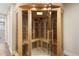 Interior view of a modern sauna featuring light wood and glass panels at 452 Deframe Ct, Golden, CO 80401
