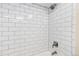 This stunning shower showcases a white subway tile surround and modern showerhead, creating a sleek and clean design at 452 Deframe Ct, Golden, CO 80401