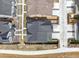 Aerial view of gray townhouses with dark roofs, fenced backyards, and concrete driveways at 608 N Bersshine Ct, Watkins, CO 80137