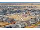 Neighborhood aerial view with a playground and green space, showcasing a community oriented setting at 608 N Bersshine Ct, Watkins, CO 80137
