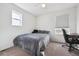 Cozy bedroom featuring neutral carpet, a ceiling fan, and a large window for natural light at 608 N Bersshine Ct, Watkins, CO 80137