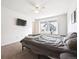 Bright bedroom with ceiling fan, large window, and neutral carpet flooring at 608 N Bersshine Ct, Watkins, CO 80137