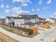 Gray townhouses with fenced yards, two car garages, and concrete driveways at 608 N Bersshine Ct, Watkins, CO 80137