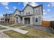 Pleasant view of two-story home in a suburban neighborhood featuring well-manicured front lawns and inviting walkways at 608 N Bersshine Ct, Watkins, CO 80137