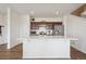 Bright kitchen with a central island, stainless steel appliances, and wooden cabinetry for a modern feel at 608 N Bersshine Ct, Watkins, CO 80137