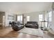 Spacious living room with hardwood floors, large windows, and contemporary furniture and decor at 608 N Bersshine Ct, Watkins, CO 80137