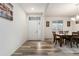 Dining room with hardwood floors, a wooden table, and access to the kitchen at 12243 Joplin St, Commerce City, CO 80603