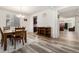 Open dining area with hardwood floors and a view into the living room at 12243 Joplin St, Commerce City, CO 80603