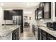 Modern kitchen with stainless steel appliances and granite countertops at 12243 Joplin St, Commerce City, CO 80603