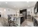 Spacious kitchen with granite island, dark cabinetry, and stainless steel appliances at 12243 Joplin St, Commerce City, CO 80603