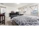 Spacious main bedroom with large bed, dresser, and plenty of natural light at 12243 Joplin St, Commerce City, CO 80603