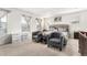 Main bedroom with plush carpet, large windows, and seating area at 12243 Joplin St, Commerce City, CO 80603