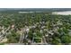 Beautiful aerial view of property surrounded by lush greenery with a lake in the distance at 4634 W Tufts Cir, Denver, CO 80236