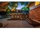 Idyllic backyard showcases a spacious deck with custom wooden features and ambient string lights, perfect for entertaining at 4634 W Tufts Cir, Denver, CO 80236