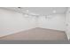 Spacious basement with neutral carpet, recessed lighting, and egress windows provides a versatile living space at 4634 W Tufts Cir, Denver, CO 80236