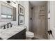 Bathroom features a walk-in shower with niche, marble vanity, and decorative mirror at 4634 W Tufts Cir, Denver, CO 80236