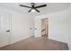 Spacious bedroom with neutral carpet, a ceiling fan, and white doors at 4634 W Tufts Cir, Denver, CO 80236
